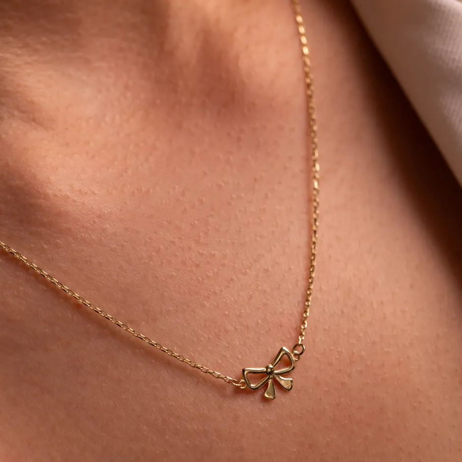 New Medley x Dinnara Micro Bow Necklace in 10k Gold Symbolic Jewellery | Necklaces & Pendants